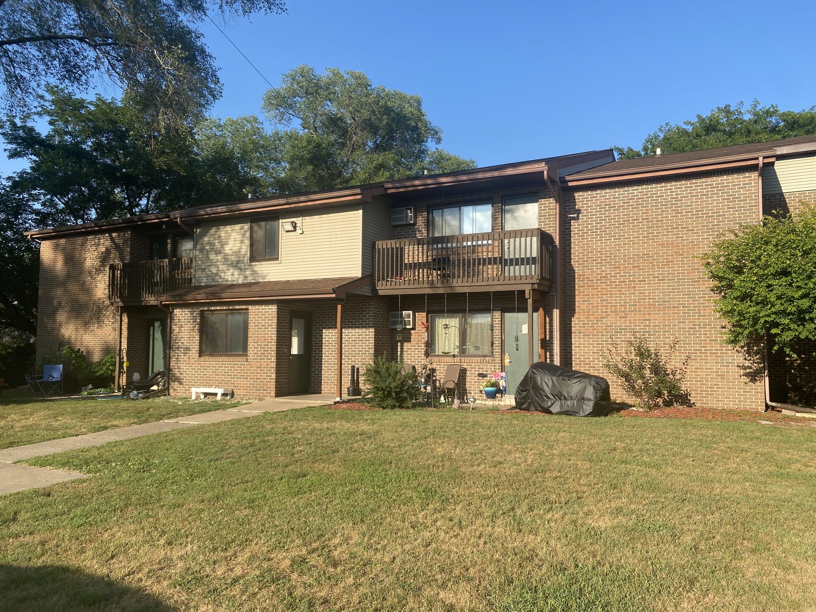 The Hummel Street building at 903 Hummel Street, Boscobel — brick apartment homes with private balconies, a covered entry, and a walkway across the front lawn.